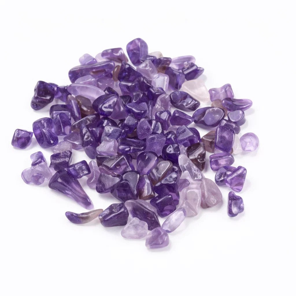Pile of amethyst crystal chips on a clean white background