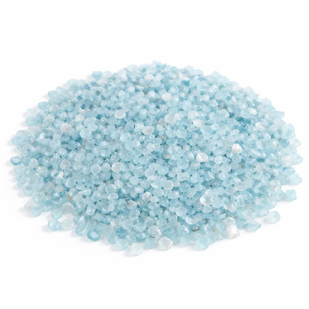 Pile of aquamarine crystal chips on a clean white background