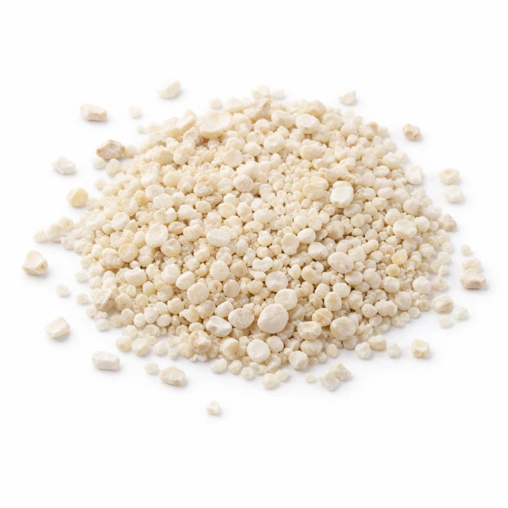 Close-up of white calcite crystal chips on a clean white background showing natural colour and texture