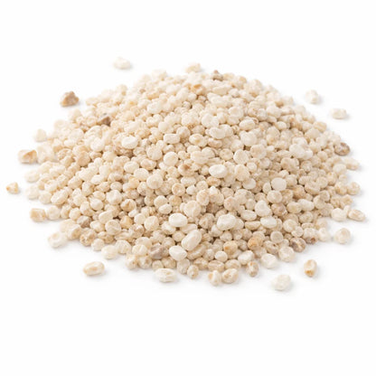 Pile of white calcite crystal chips on a clean white background