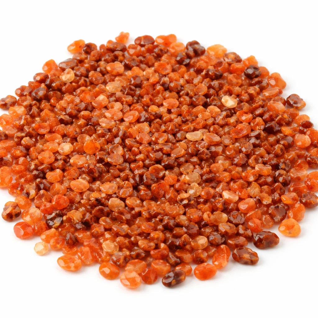 Close-up of carnelian crystal chips on a clean white background showing natural colour and texture