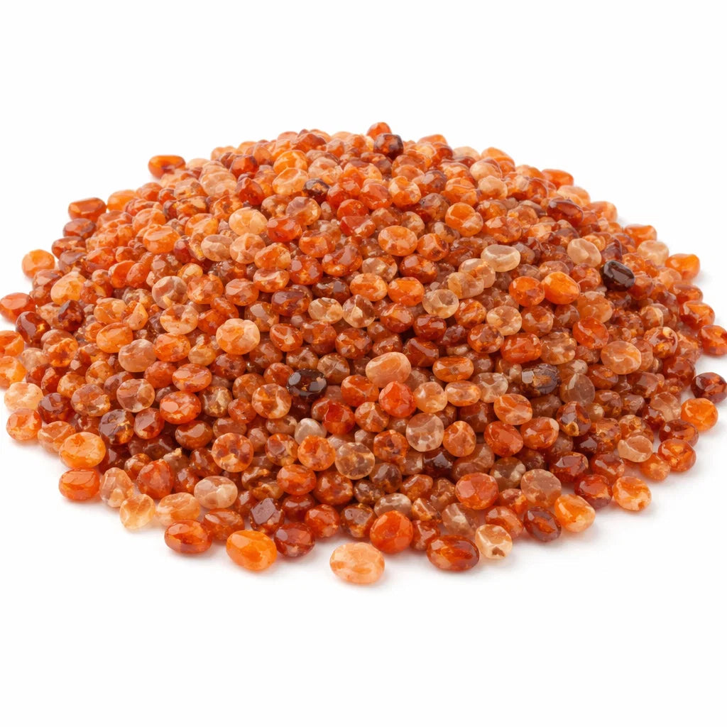 Pile of carnelian crystal chips on a clean white background