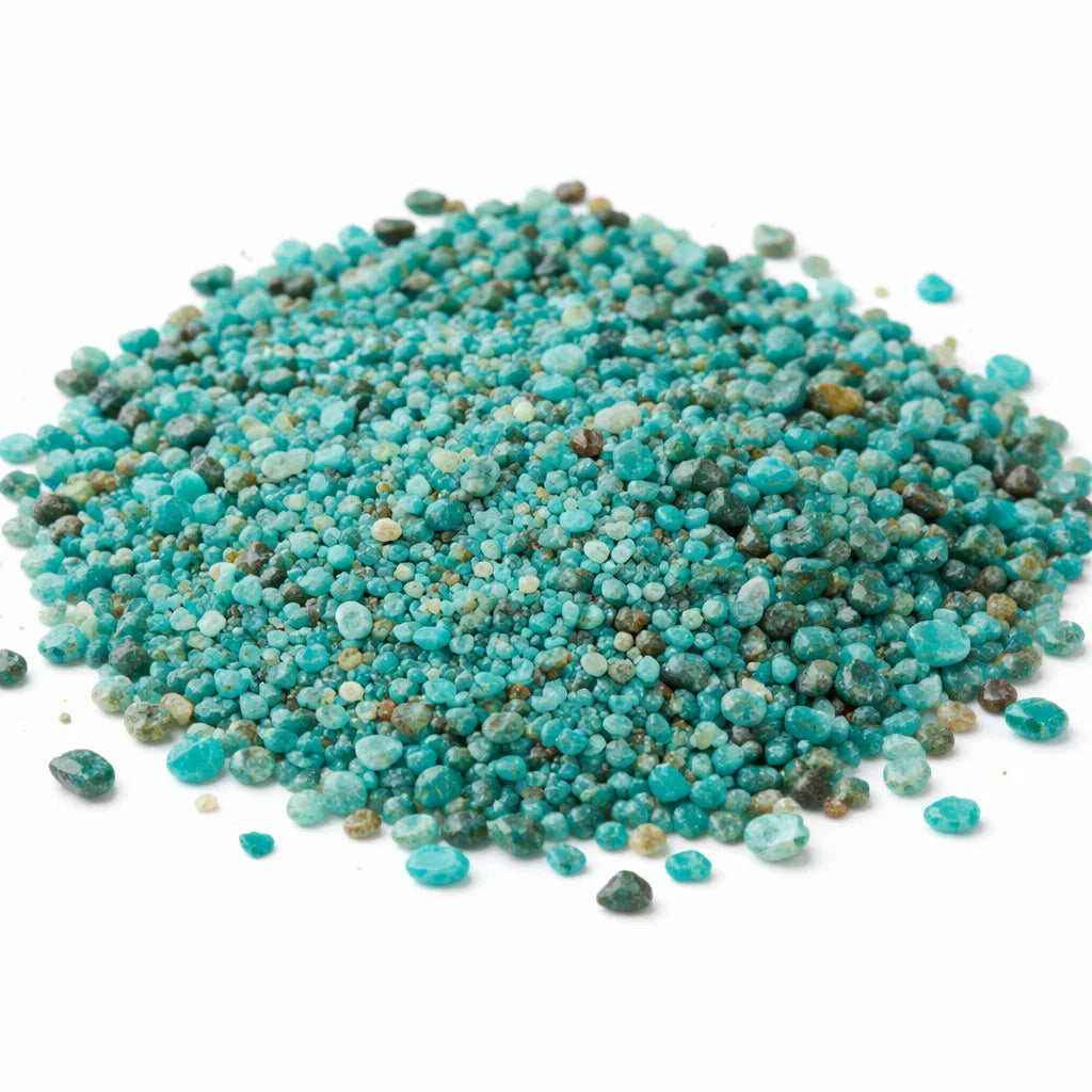 Close-up of chrysocolla crystal chips on a clean white background showing natural colour and texture