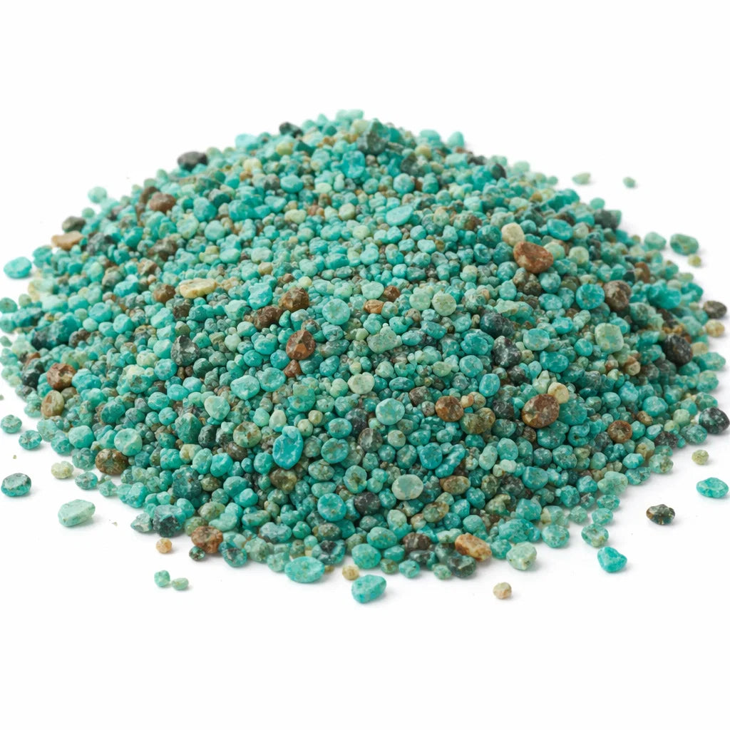 Pile of chrysocolla crystal chips on a clean white background