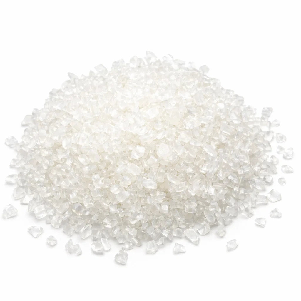 Close-up of clear quartz crystal chips on a clean white background showing natural colour and texture