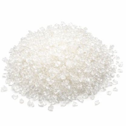 Close-up of clear quartz crystal chips on a clean white background showing natural colour and texture