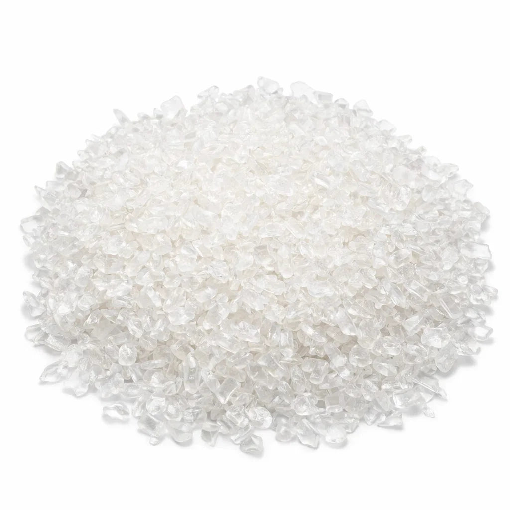 Pile of clear quartz crystal chips on a clean white background