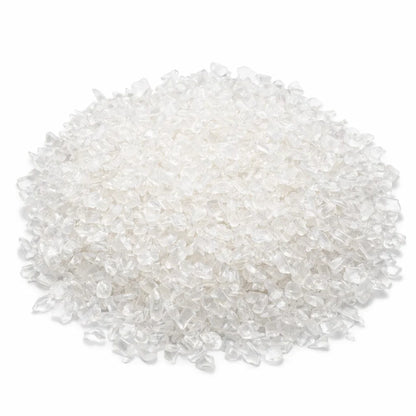 Pile of clear quartz crystal chips on a clean white background
