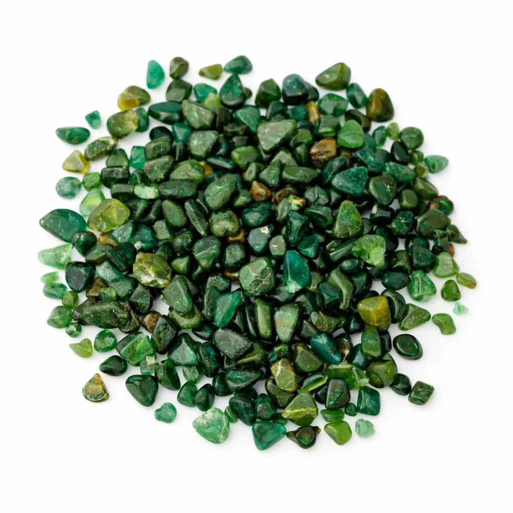Close-up of emerald crystal chips on a clean white background showing natural colour and texture