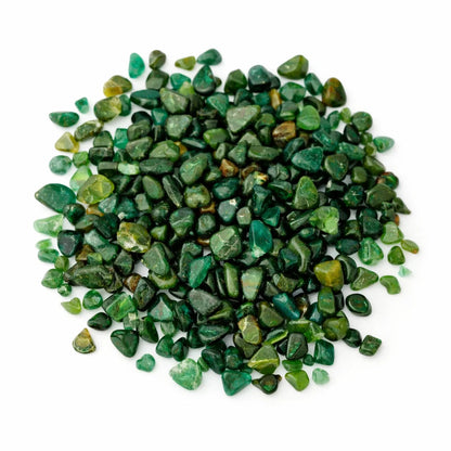 Close-up of emerald crystal chips on a clean white background showing natural colour and texture