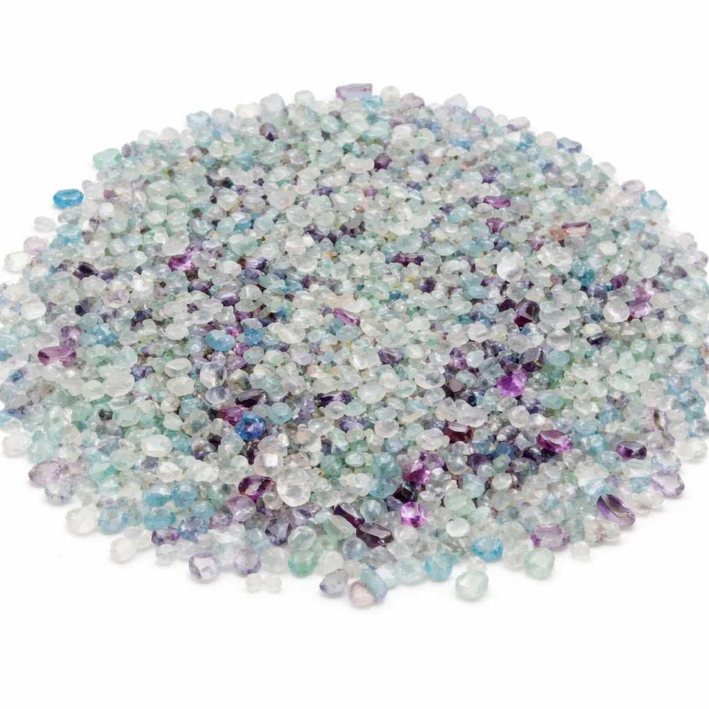 Pile of fluorite crystal chips on a clean white background