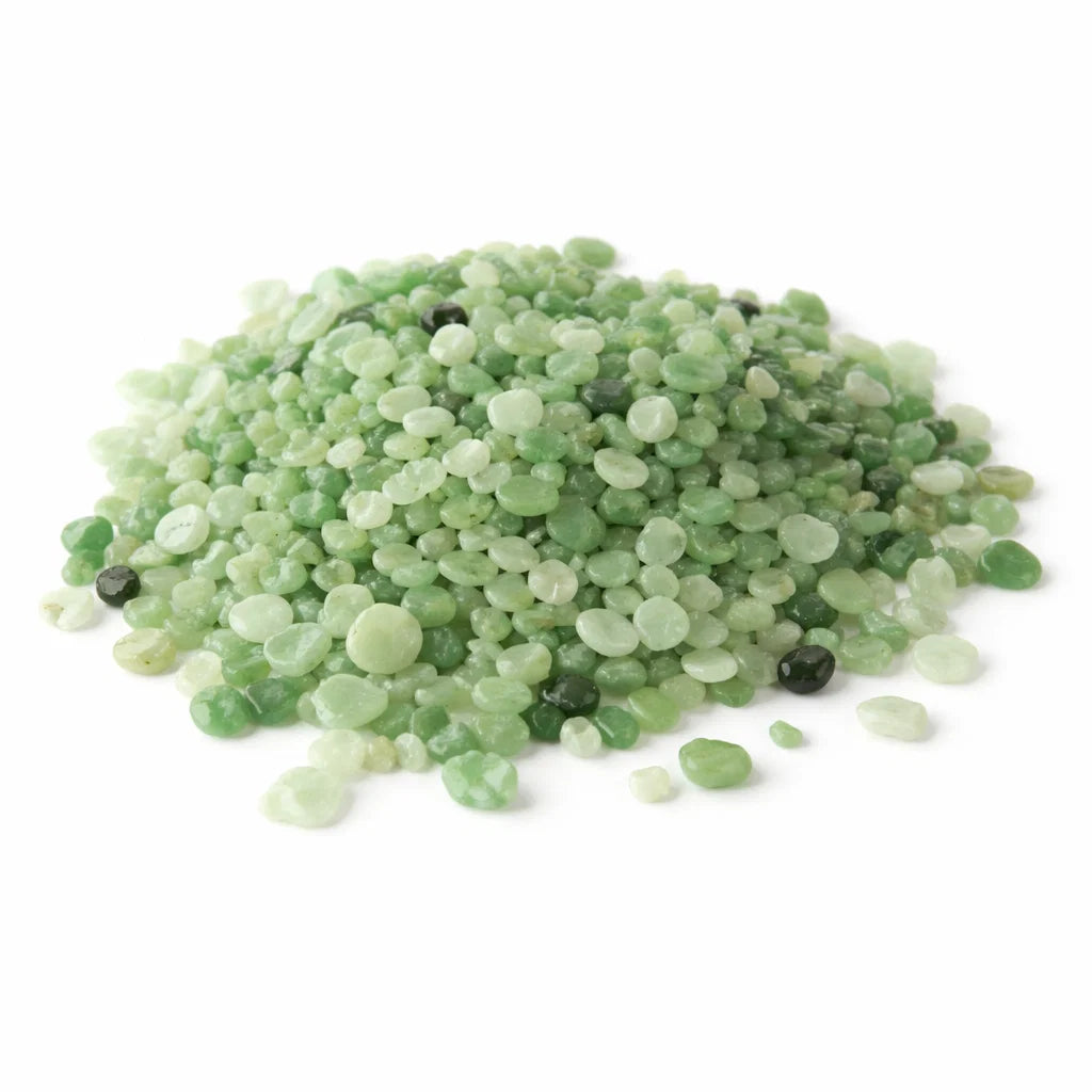 Close-up of green aventurine crystal chips on a clean white background showing natural colour and texture