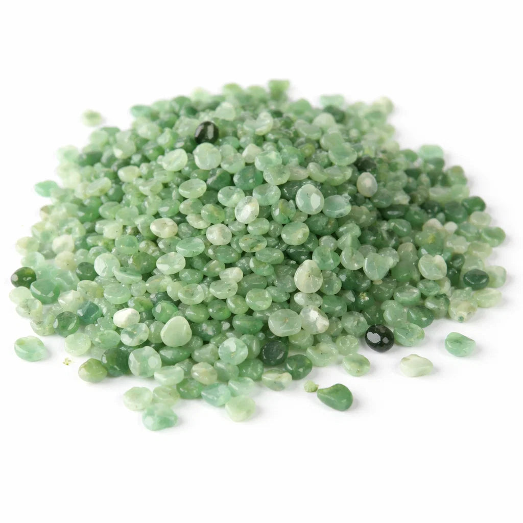 Pile of green aventurine crystal chips on a clean white background
