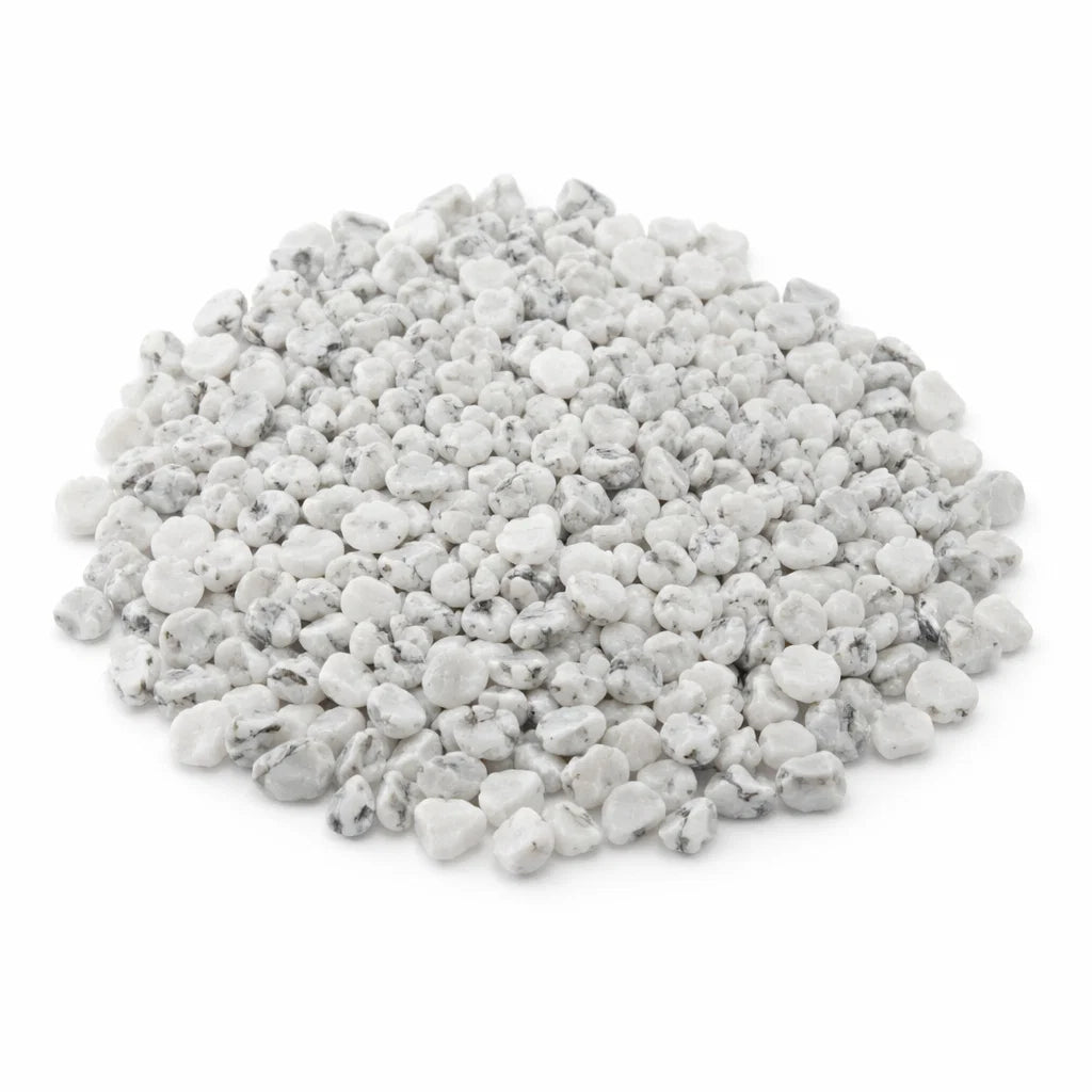 Close-up of howlite crystal chips on a clean white background showing natural colour and texture