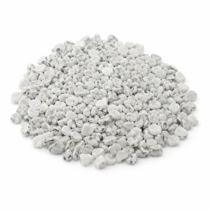 Close-up of howlite crystal chips on a clean white background showing natural colour and texture