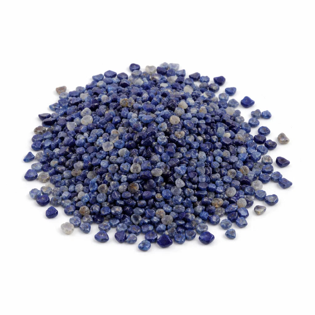 Close-up of lapis lazuli crystal chips on a clean white background showing natural colour and texture