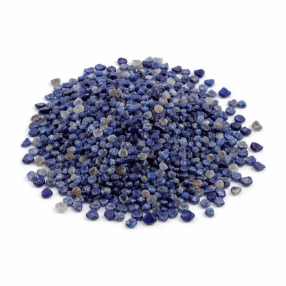 Close-up of lapis lazuli crystal chips on a clean white background showing natural colour and texture