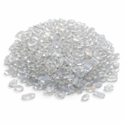 Close-up of opalite crystal chips on a clean white background showing natural colour and texture