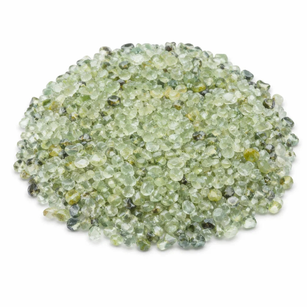 Pile of prehnite crystal chips on a clean white background