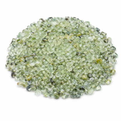 Pile of prehnite crystal chips on a clean white background