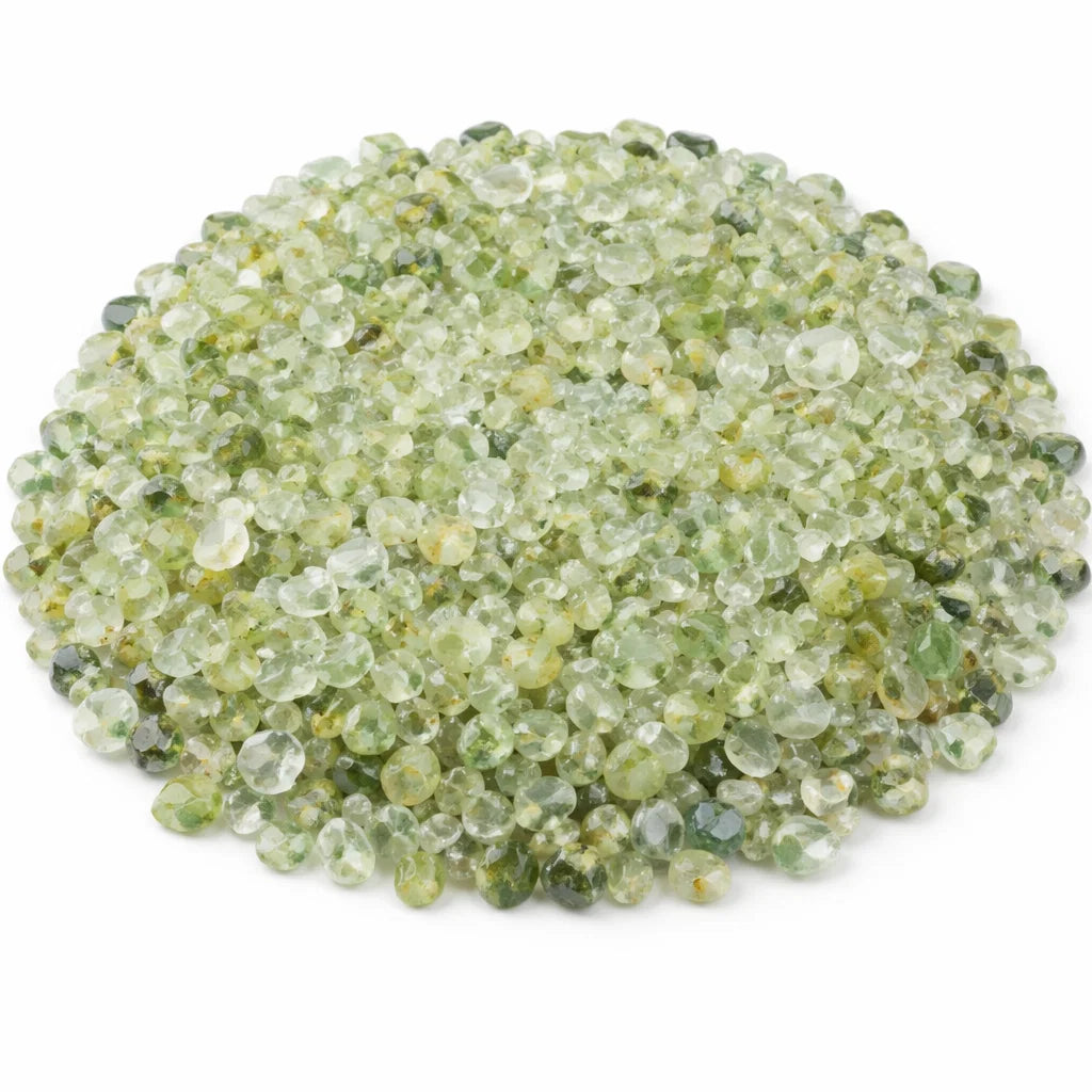 Close-up of prehnite crystal chips on a clean white background showing natural colour and texture
