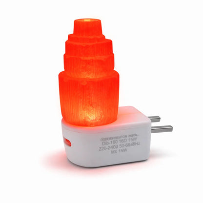 Selenite tower lamp illuminated red on its white USB base against a clean background