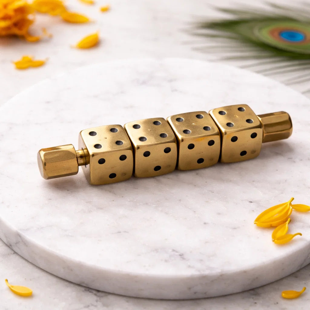 Single brass Ramal Pass rod with five rotating dice on a white marble plate