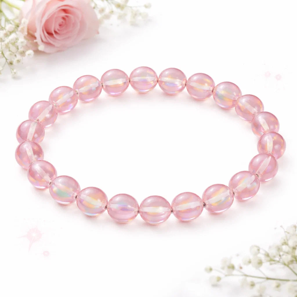 Natural light pink aura quartz crystal bracelet presented with a hand for visual scale
