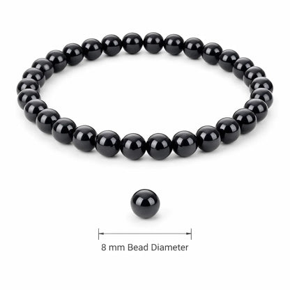 Natural black obsidian crystal bracelet with round beads on a clean white background