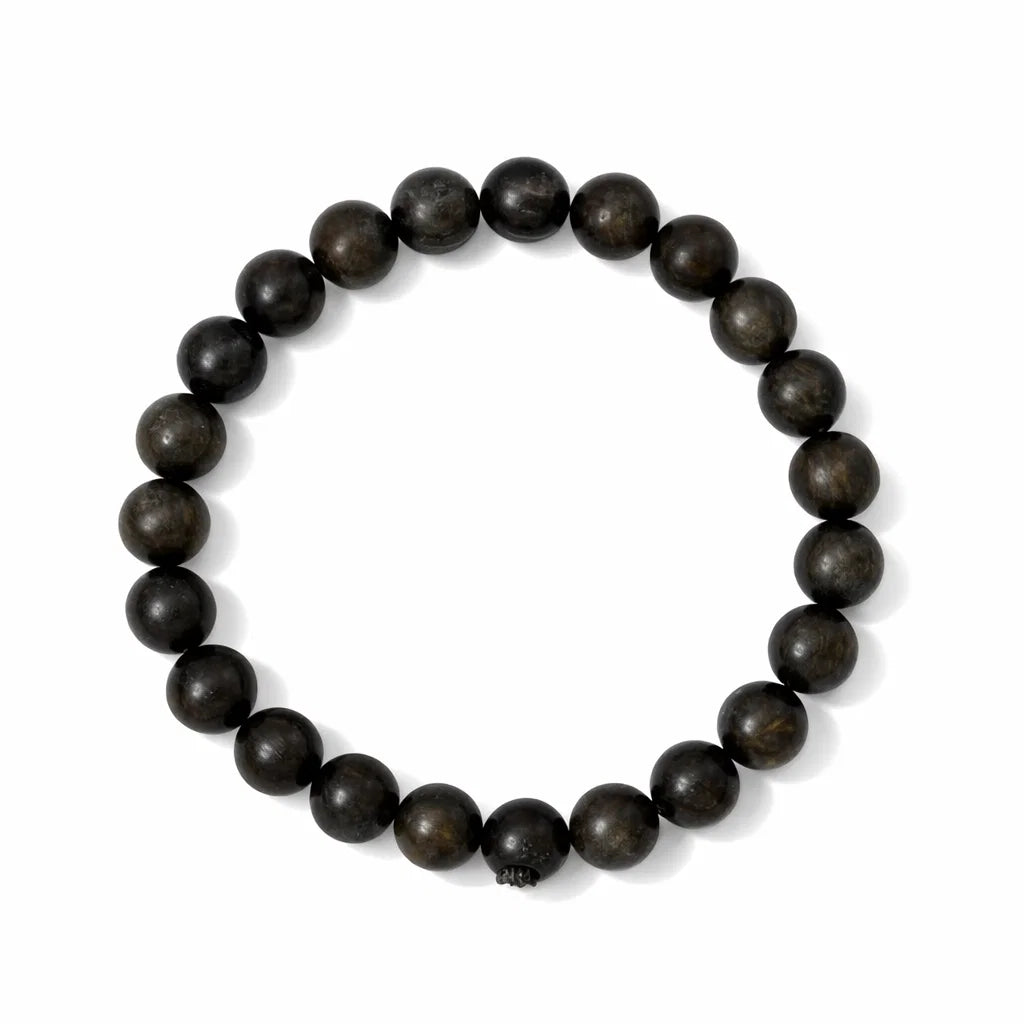 Natural bronzite crystal bracelet with round beads on a clean white background