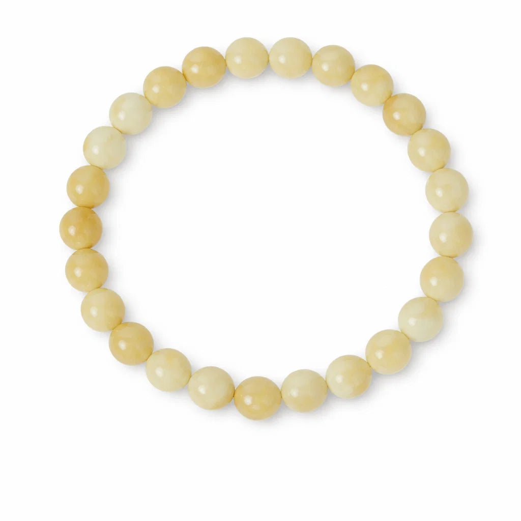 Natural calcite crystal bracelet with round beads on a clean white background