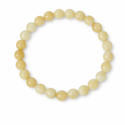 Natural calcite crystal bracelet with round beads on a clean white background