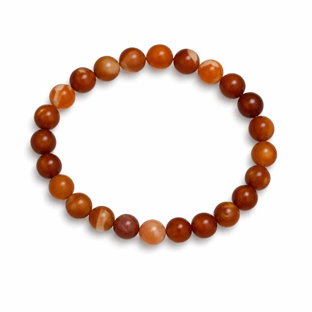 Natural carnelian crystal bracelet with round beads on a clean white background