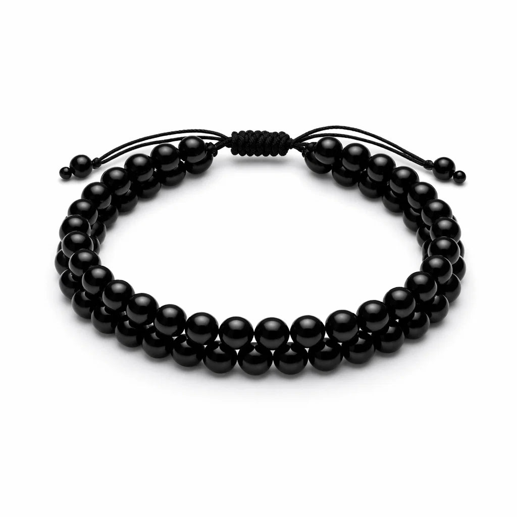 Natural black tourmaline dual strand bracelet with round beads on a clean white background
