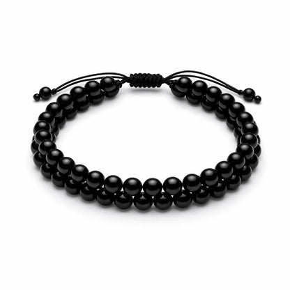 Natural black tourmaline dual strand bracelet with round beads on a clean white background