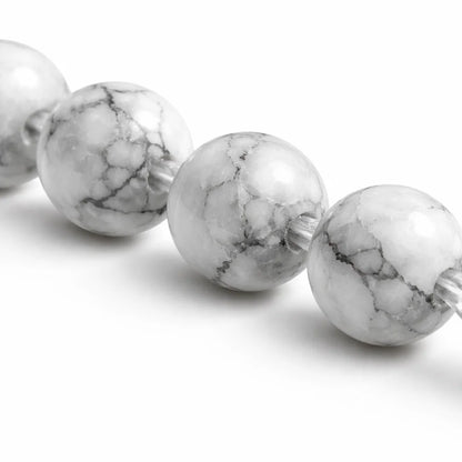 Natural howlite crystal bracelet with round beads on a clean white background