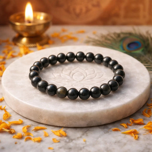 Golden sheen obsidian crystal bracelet shown with a hand in a lifestyle photograph