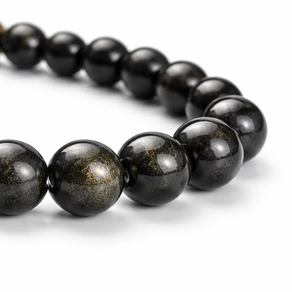 Golden sheen obsidian crystal bracelet with round beads on a clean white background