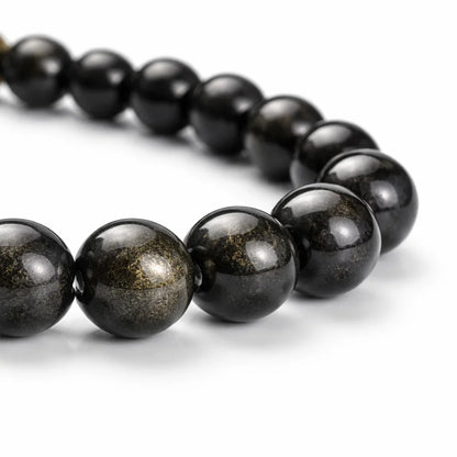 Golden sheen obsidian crystal bracelet with round beads on a clean white background