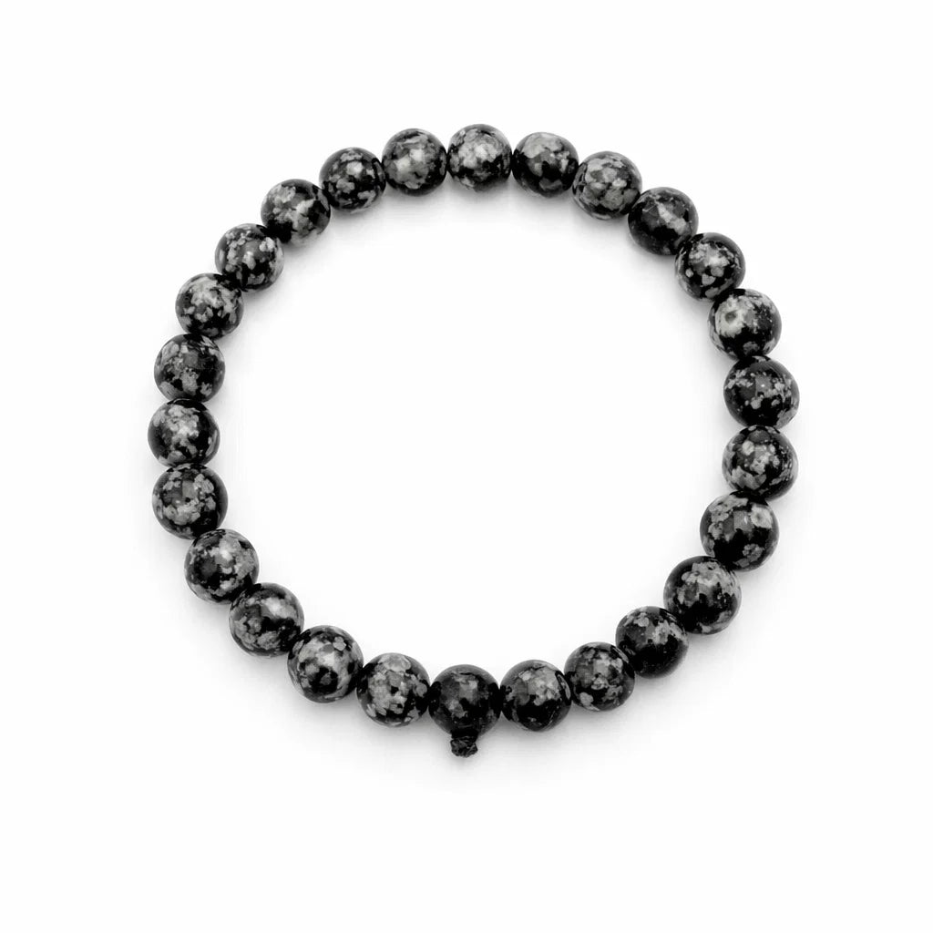 Natural snowflake obsidian crystal bracelet showing the bead colour and surface on white