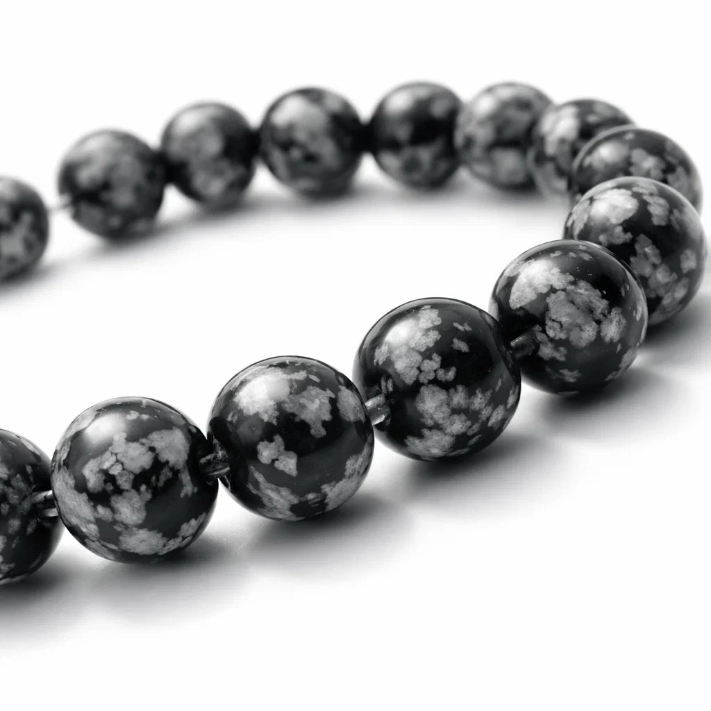 Natural snowflake obsidian crystal bracelet in a close white-background bead view