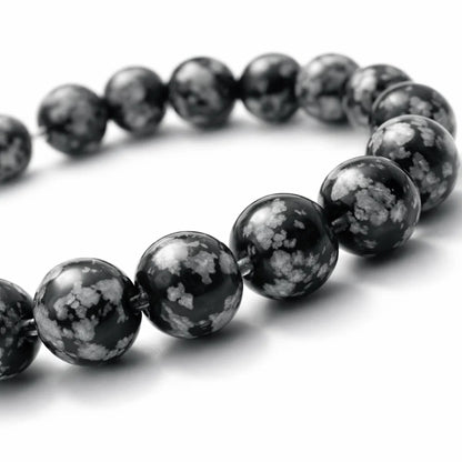 Natural snowflake obsidian crystal bracelet in a close white-background bead view