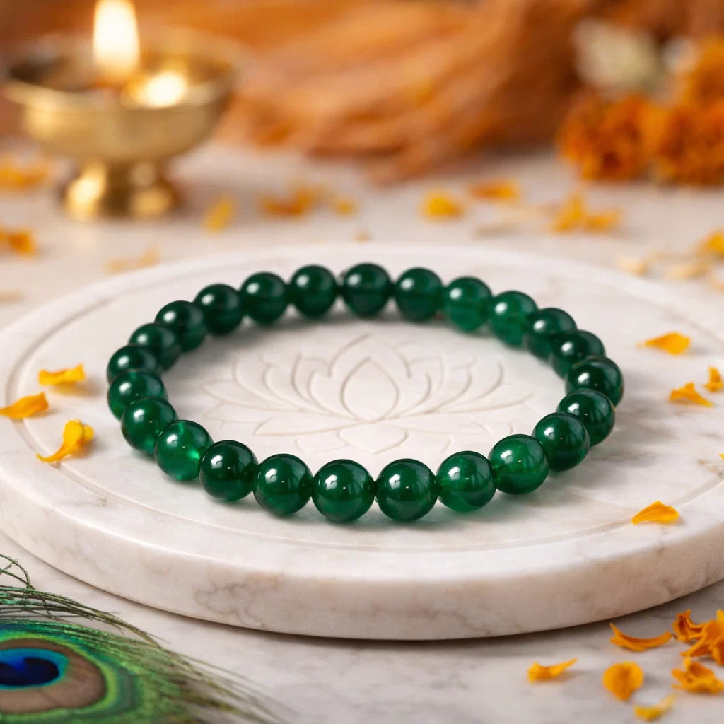 Natural green jade crystal bracelet presented with a hand for visual scale
