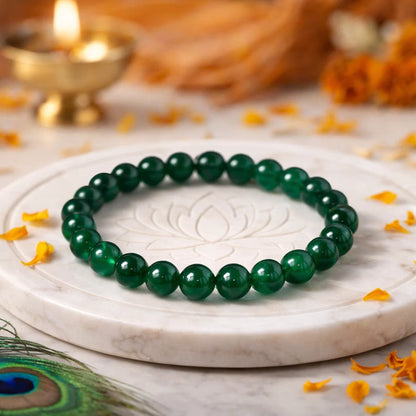 Natural green jade crystal bracelet presented with a hand for visual scale