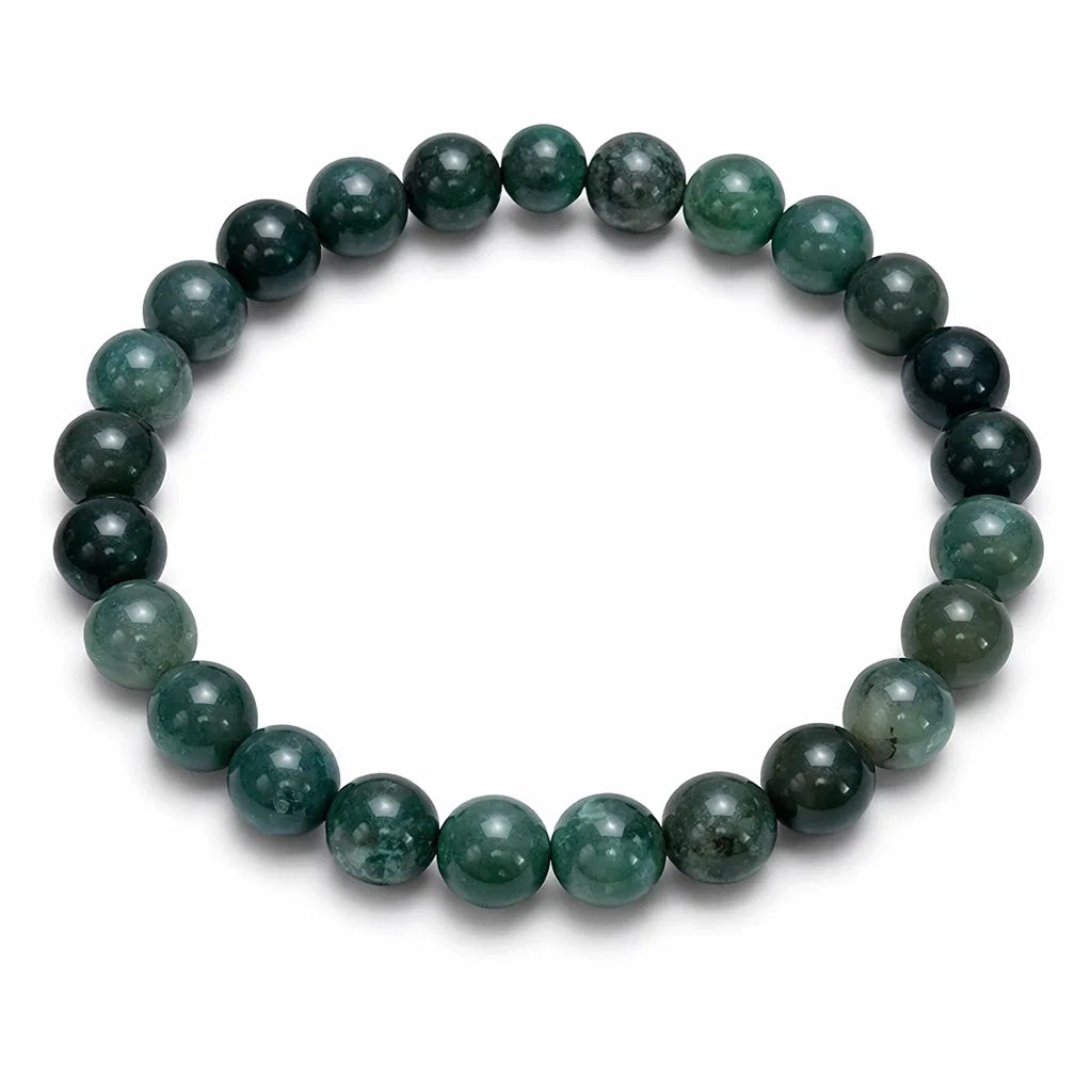 Natural moss agate crystal bracelet showing the bead colour and surface on white