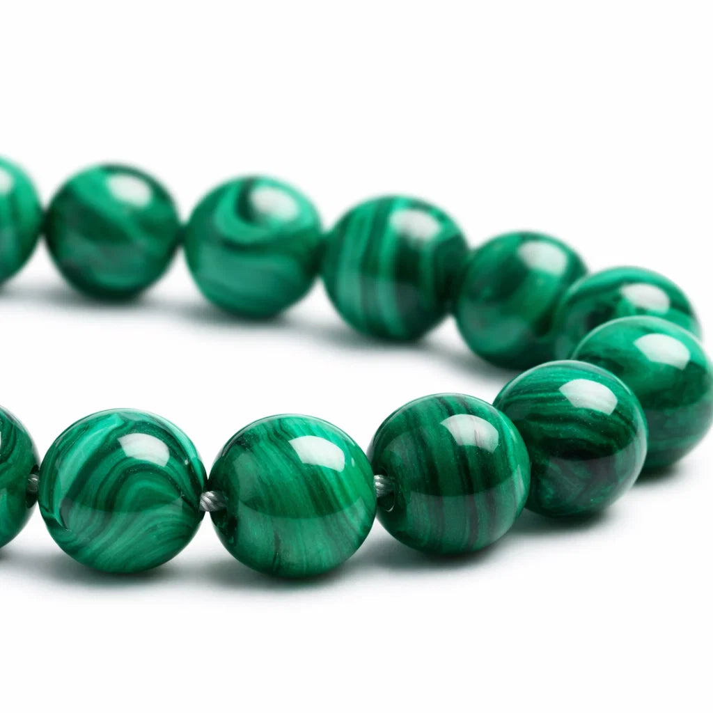 Natural malachite crystal bracelet with round beads on a clean white background