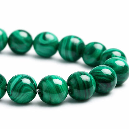 Natural malachite crystal bracelet with round beads on a clean white background
