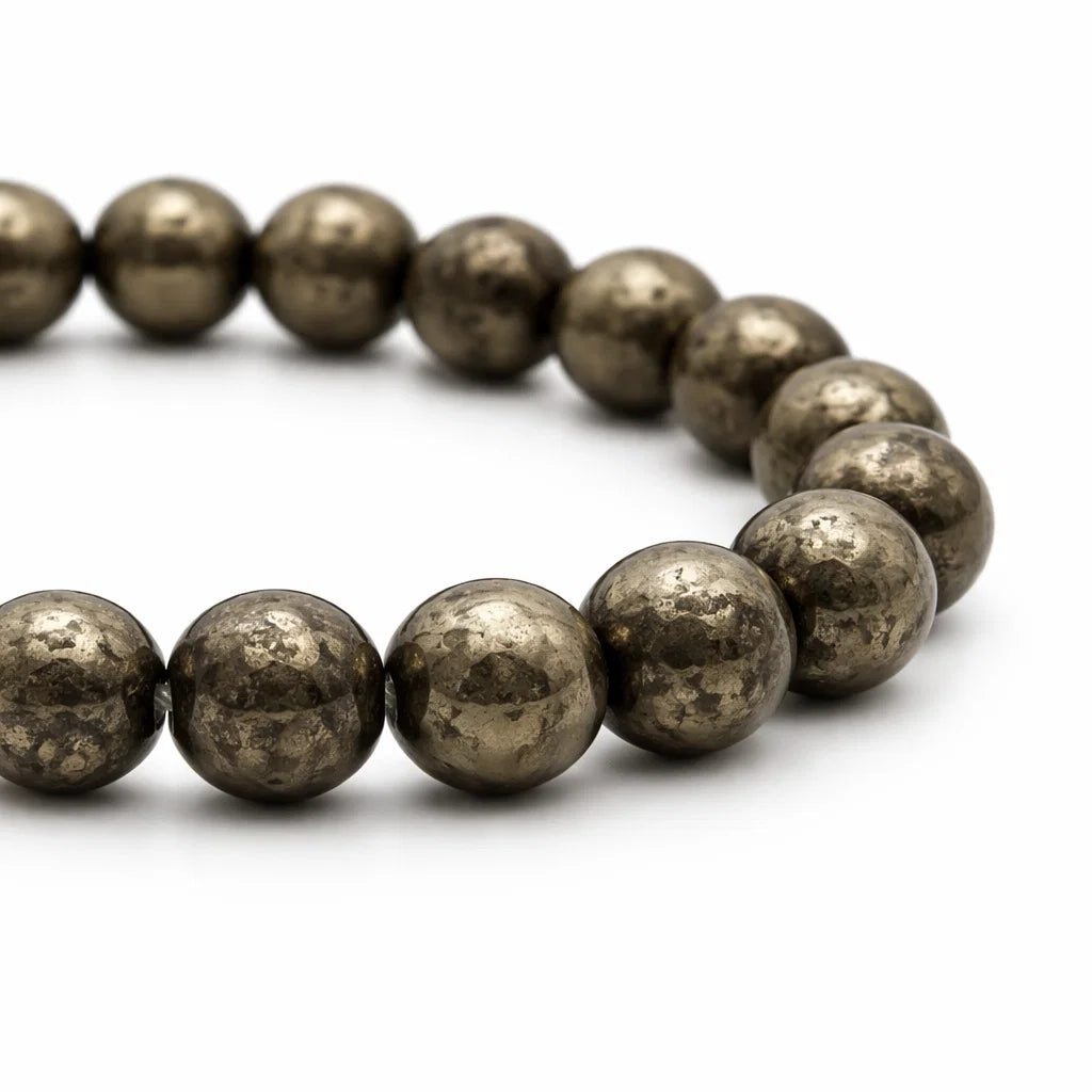 Natural pyrite bracelet with round beads on a clean white background