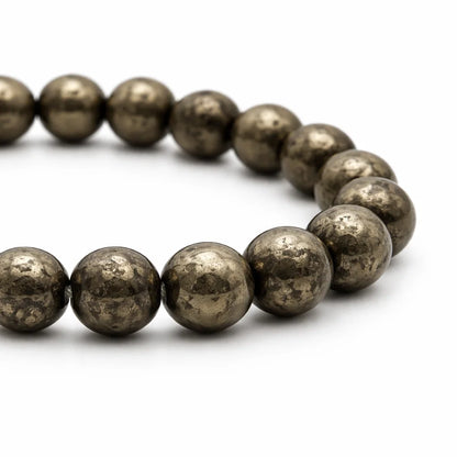Natural pyrite bracelet with round beads on a clean white background