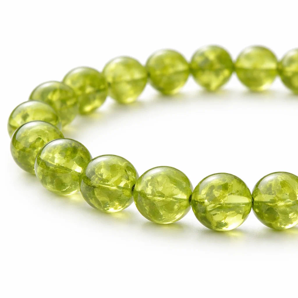 Natural peridot crystal bracelet with round beads on a clean white background